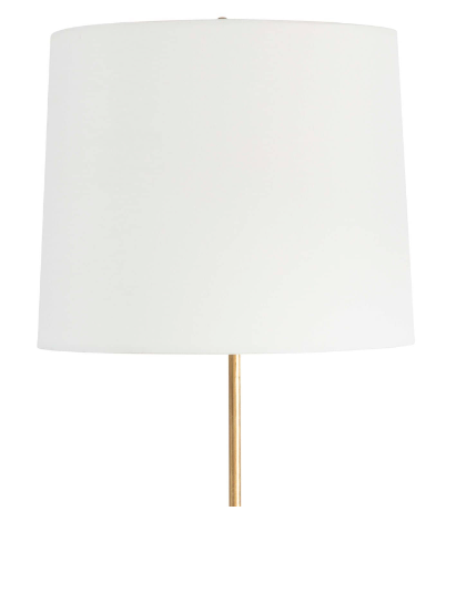 Gold lamp with white background and white lamp shade.