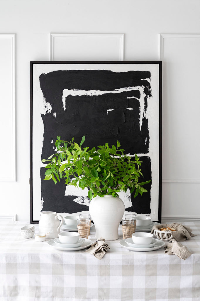 Solo black artwork on table with white wall behind