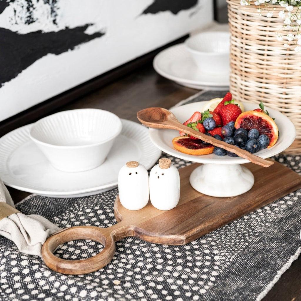 Table Runner with dot pattern on wood table with table setting and basket with black and white art behind