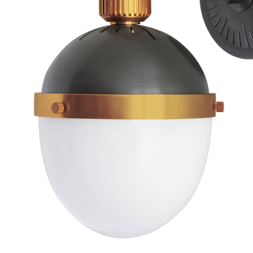 Black and gold otis sconce on white wall.