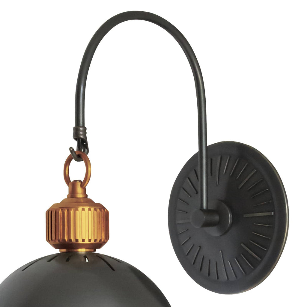 Black and gold otis sconce on white wall.