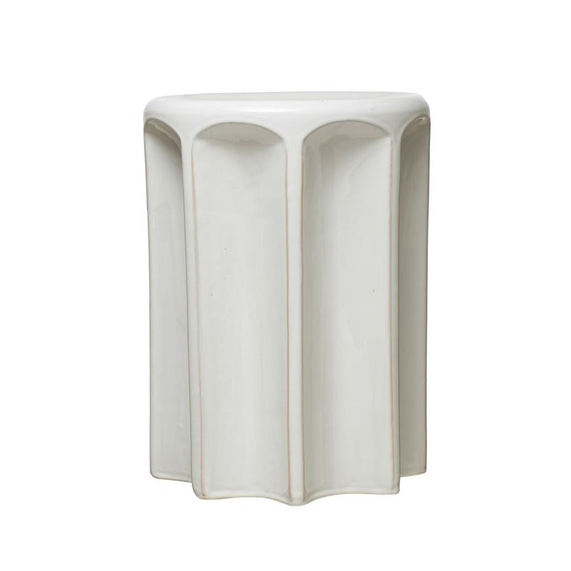 sculpted white stoneware stool on white background