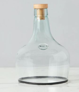 glass cloche with copper rim bottom and wine cork stopper   with white background 