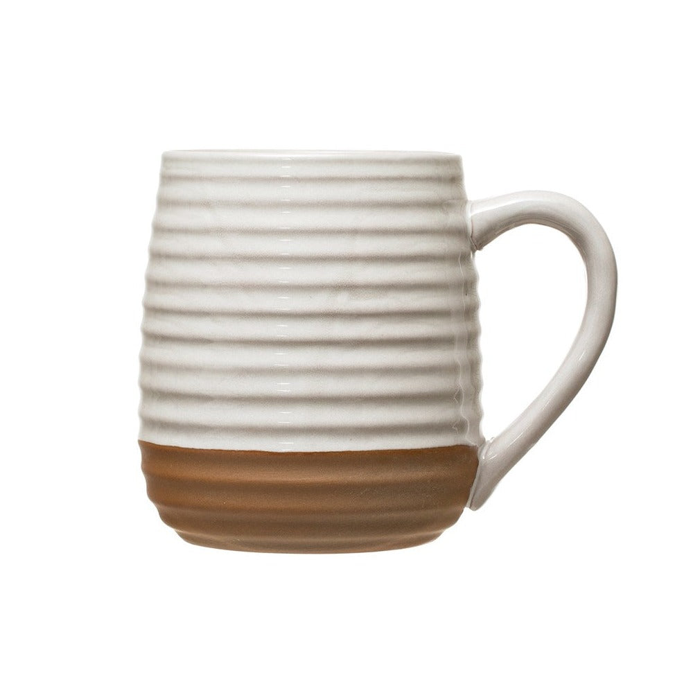 White stoneware coffee mug with natural terracotta base on white background